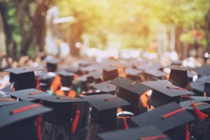 a crowd of people dressed in graduation robes and caps